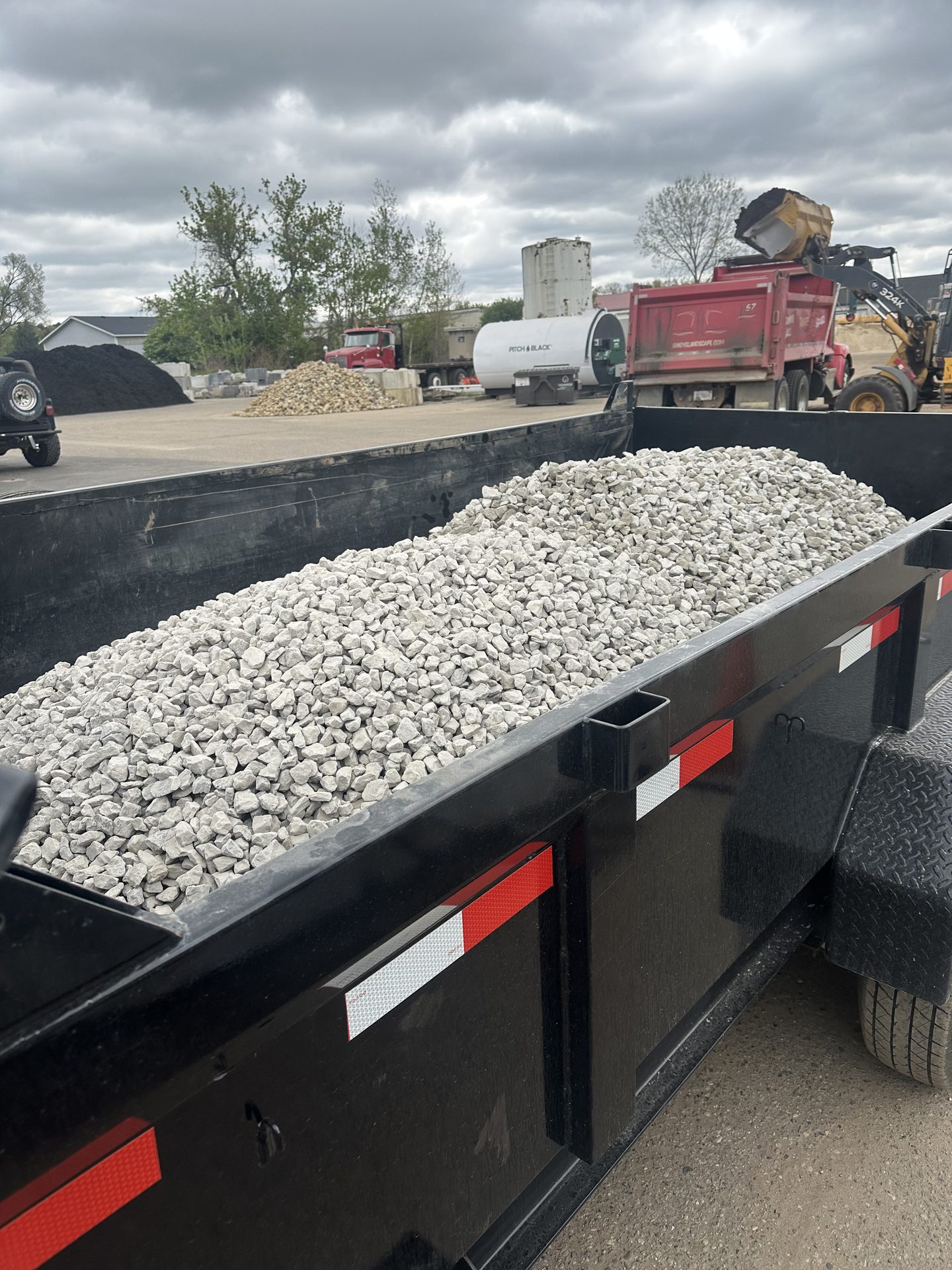 Dump trailer loaded with crushed limestone gravel ready for delivery in Jackson, MI